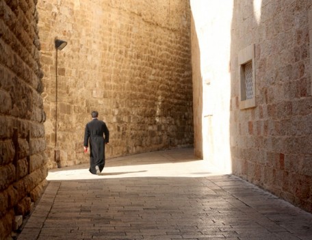 priest in street - City Dwellers