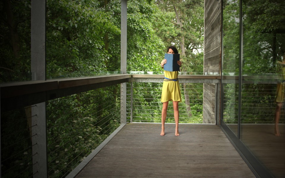 girl on balcony with book