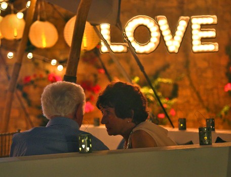 elderly couple by love sign - Elixir Shore Club