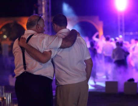 men hug at party - The Jumeirah Hotel