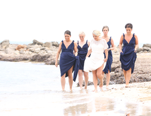 bride and bridesmaids on beach