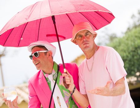 Men in pink with parasol - Pikes Hotel