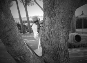 wedded couple bbehind tree