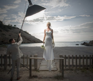 girl with photographic light at beach