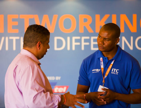 men in front of banner - ITC Malta