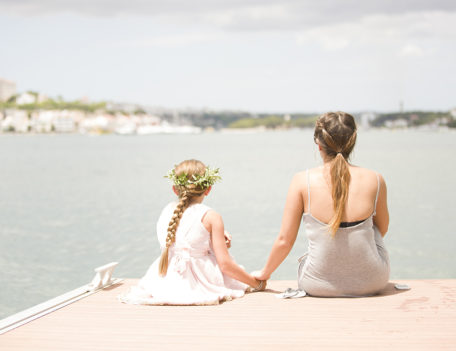 woman and girl by water holding hands - Casa Venecia Anniversary