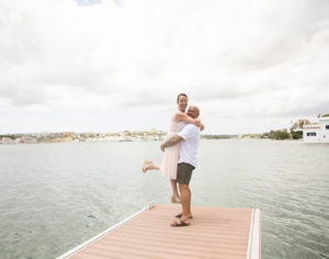 man holding woman aloft