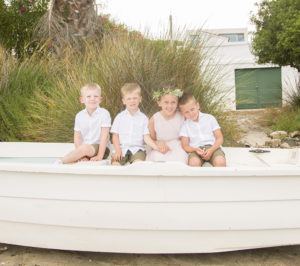 four kids sat in a small boat