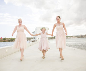 three girls run toward camera