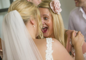 bride and friend laugh at wedding
