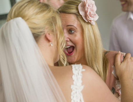 bride and friend laugh at wedding - Binifadet