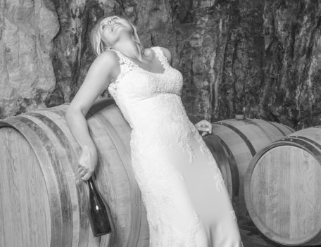 woman on distilling barrels - Binifadet Basement