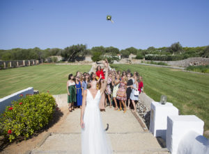 Bride throwing flowers into crows