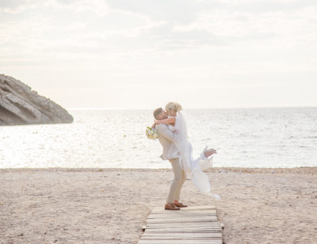 couple embrace on beach - Ca’s Mila