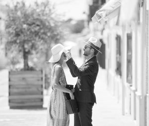 man puts hat on woman