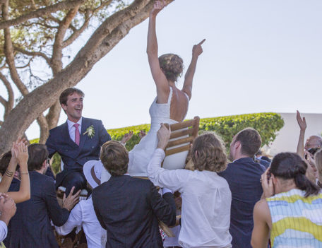 bride and groom on chairs aloft - Hotel Sant Joan de Binissaida