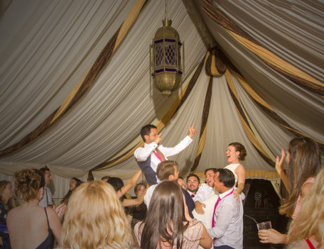 bride and groom held aloft - Ca’s Xorc