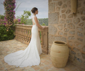 bride poses on balcony