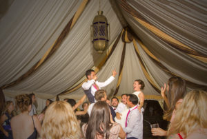 couple held aloft at wedding party