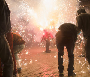 man with firework in crowd