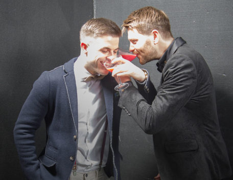 two men swanning drinks - The Manhattan Club