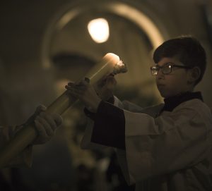 boy with alter candle