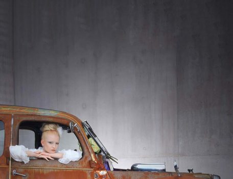 woman in window of car - The Wedding Car