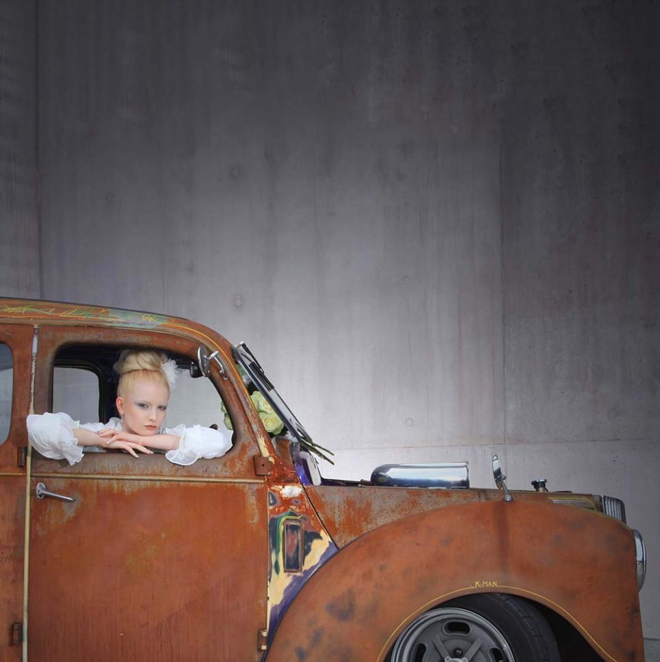 woman in window of car