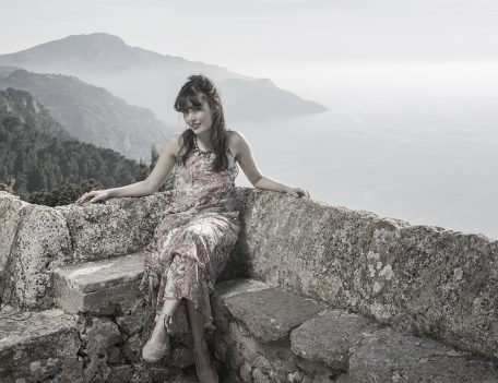 woman on stone seated area - Portrait Photography