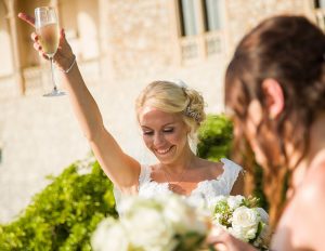 bride celebrates with champagne glass