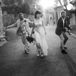 bride with two men descending street