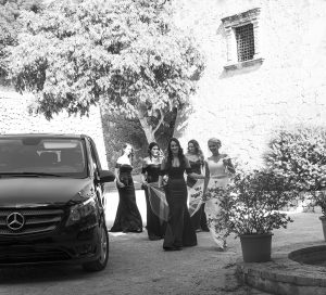 bride with her bridesmaids alighting the wedding car