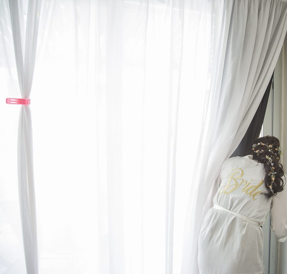 bride peeping through curtain