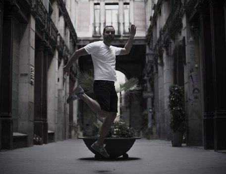 man jumps in Barcelona arcade - Gothic Quarter Shoot