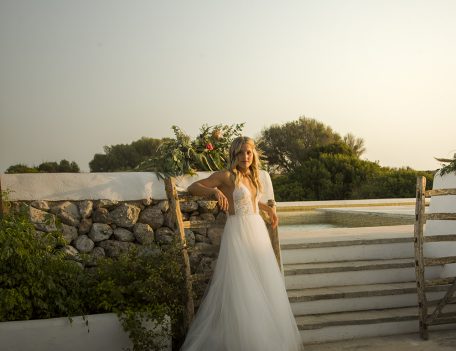 bride leaning on Menorcan gate - Villa Binisegarra