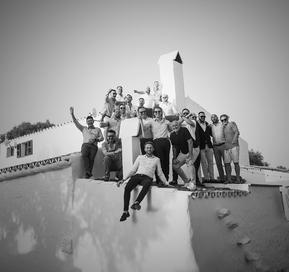 Group wedding photo on villa roof