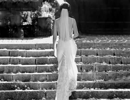 Bride walking up steps - Dalt Des Coll