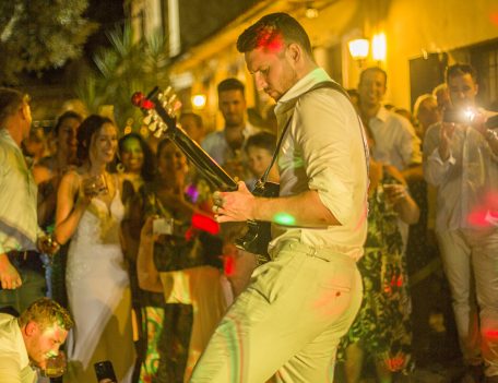 Groom playing guitar - Dalt Des Coll